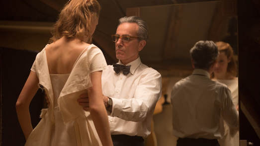 A screencap from Phantom Thread, by Paul Thomas Anderson. Daniel Day Lewis fits a dress onto his lover.